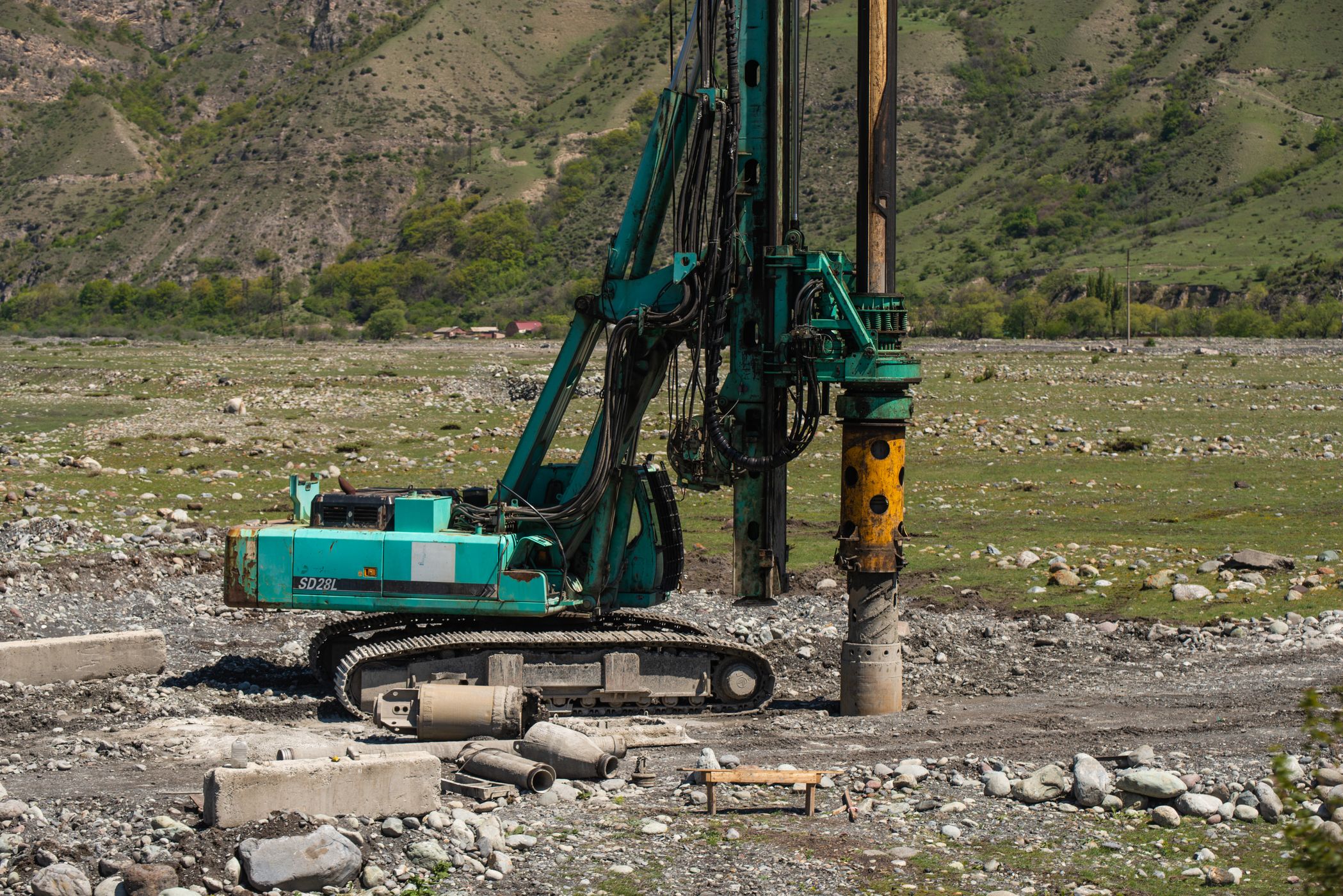 Drilling rig at work in a mountain valley